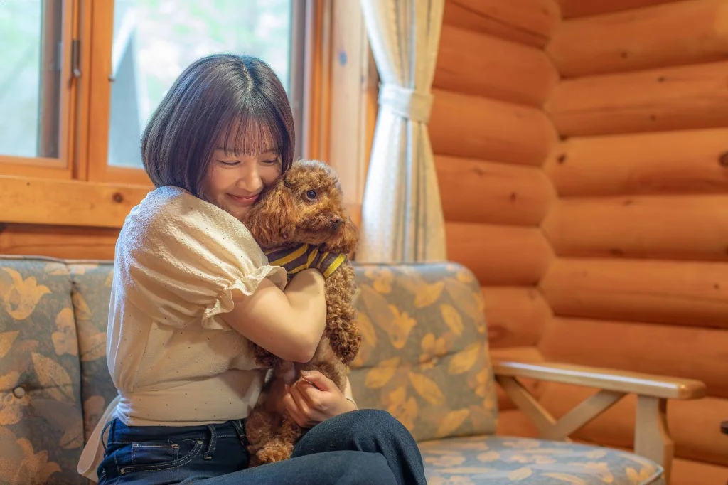 Hugging a dog in the cottage